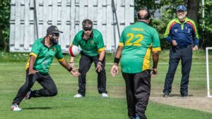 Berkshire Stags' Moshfique to field at mid off watched by bowler Sam, Atif in foreground
